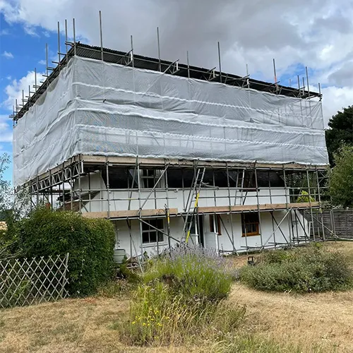 house with scaffolding sheet